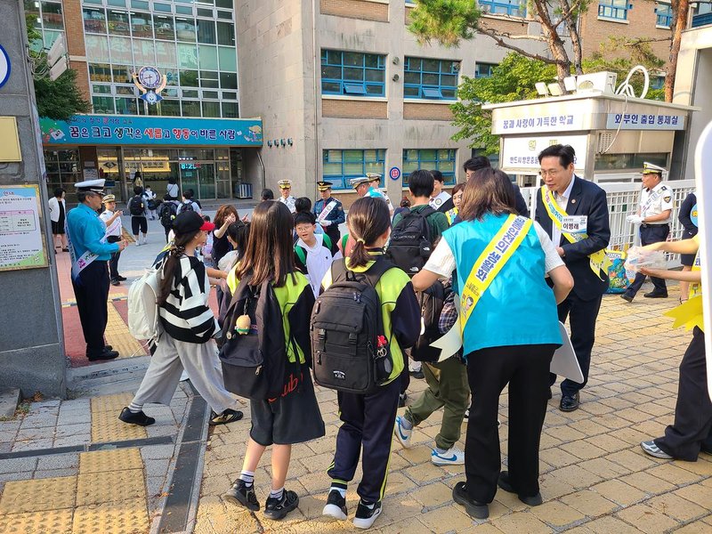 정각초등학교 일대에서 구청·경찰·학교 관계자와 모범운전자회, 녹색어머니회 회원들이 어린이 교통안전 캠페인을 하고 있다.